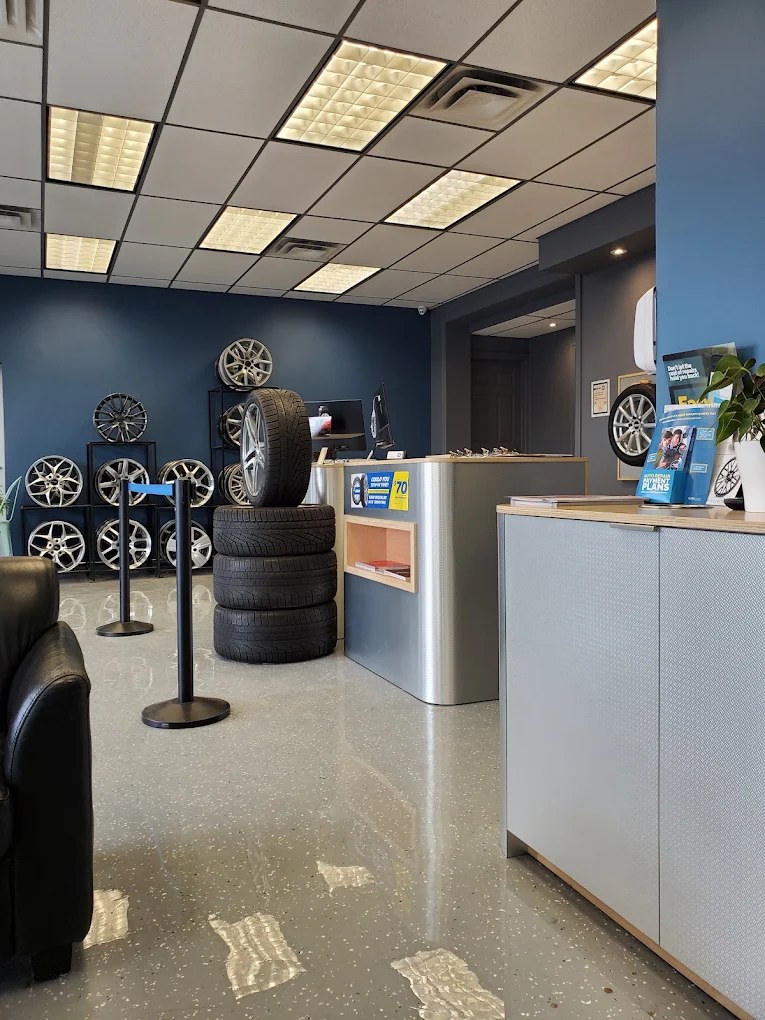 The Hello Tire service counter with stacked tires and a wall of wheels