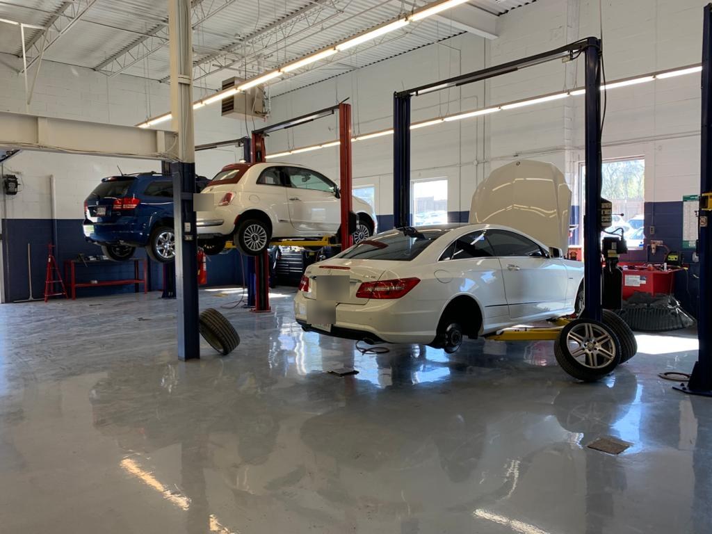 Cars on lifts in the Hello Tire service bays